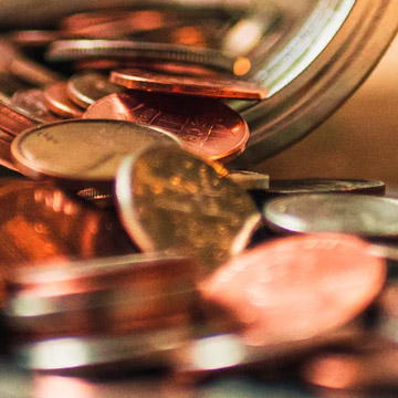 coins pouring out of jar